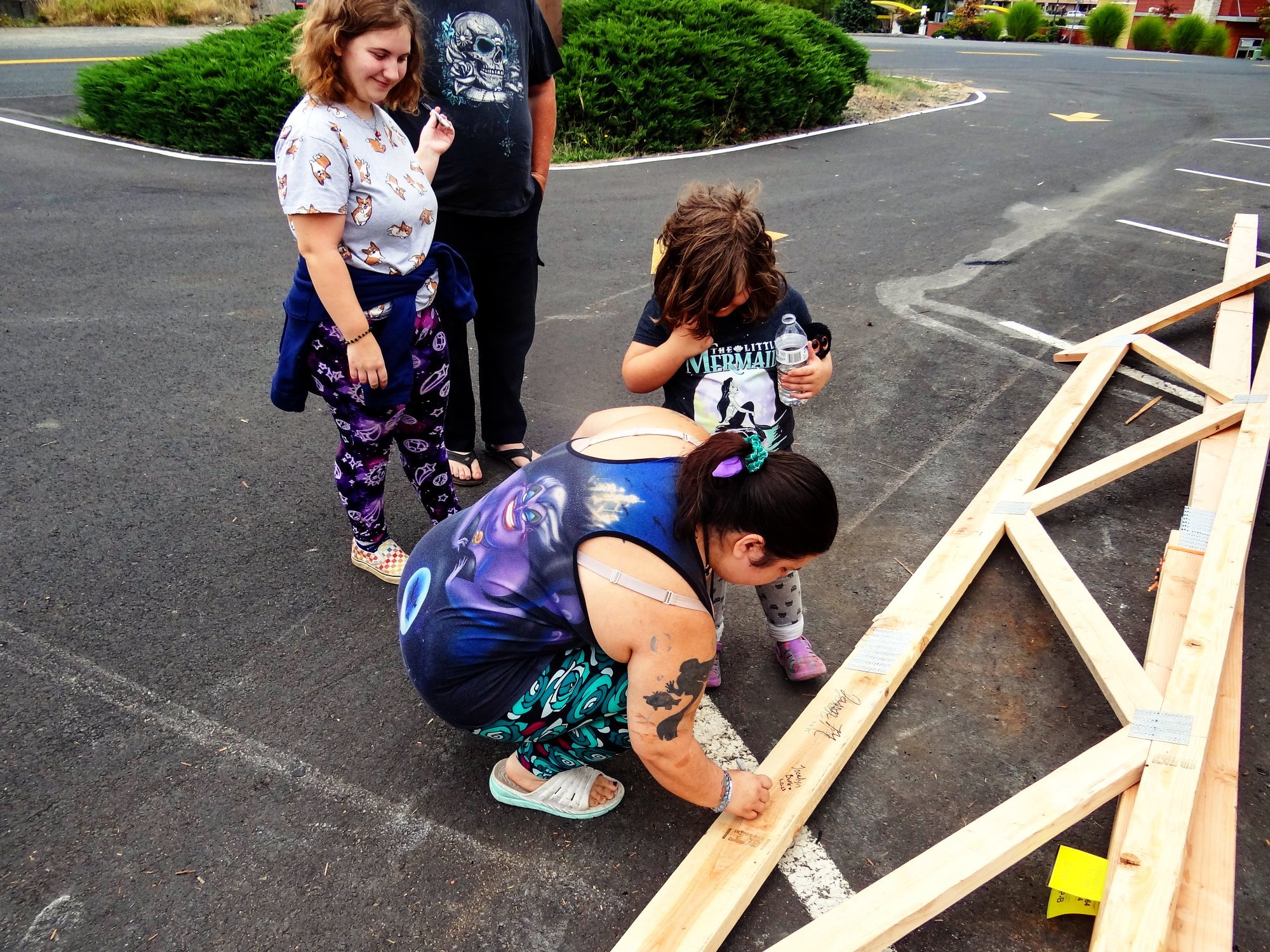 A family signs the new trusses