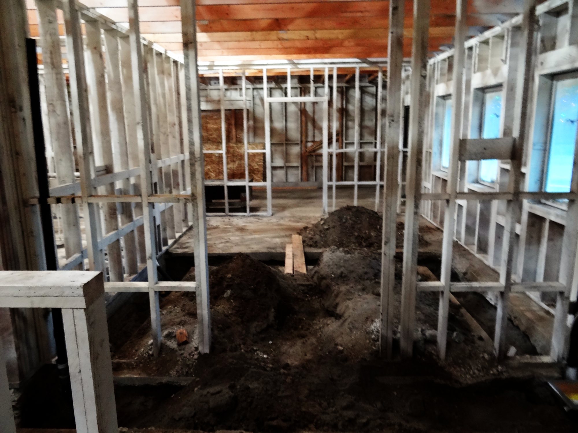 The gutted interior with new framing and trenches