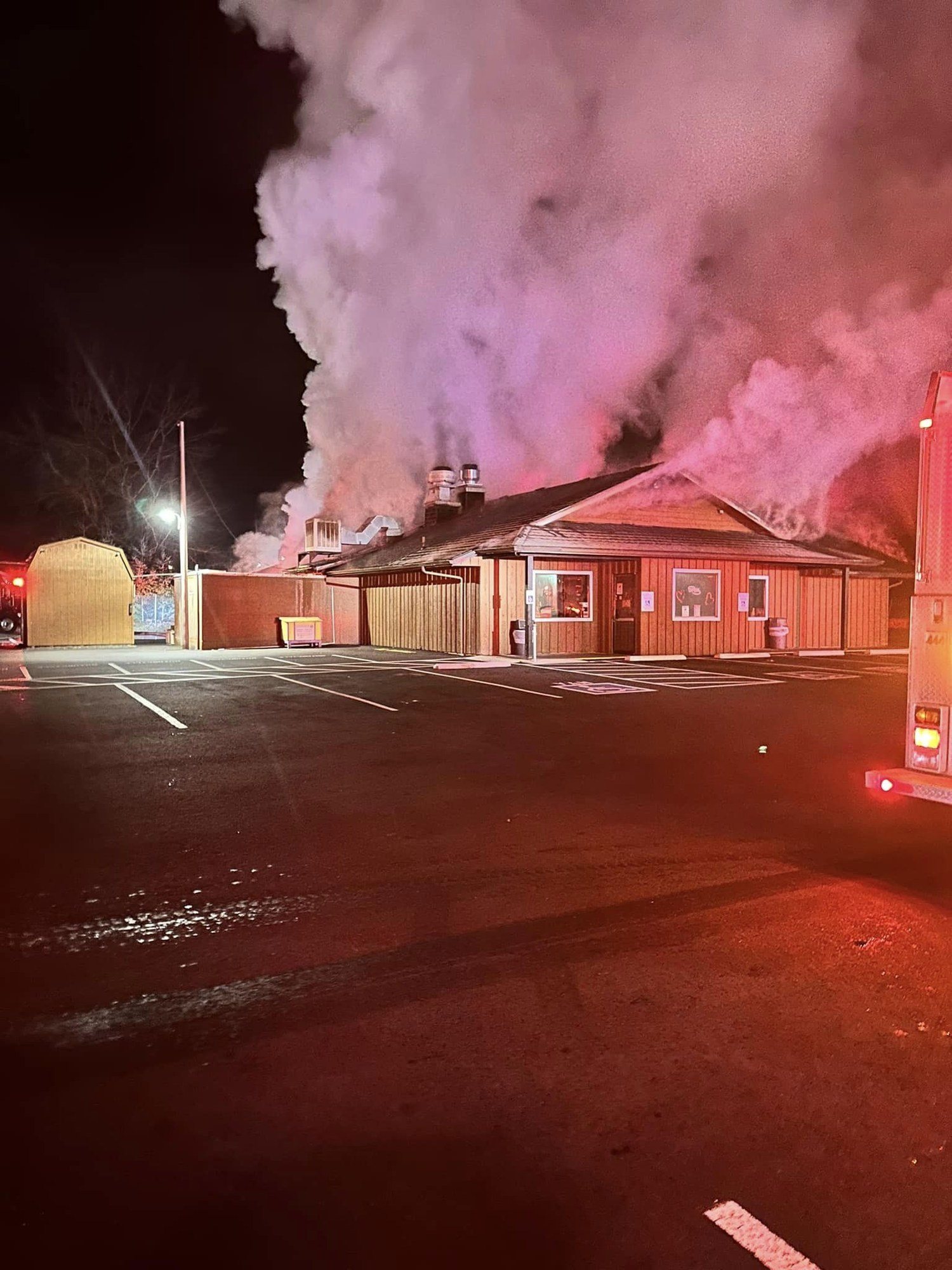The building engulfed in smoke the night of the fire