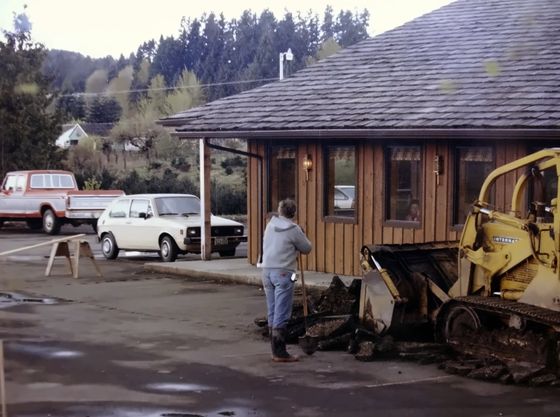A bulldozer outside the building during construction